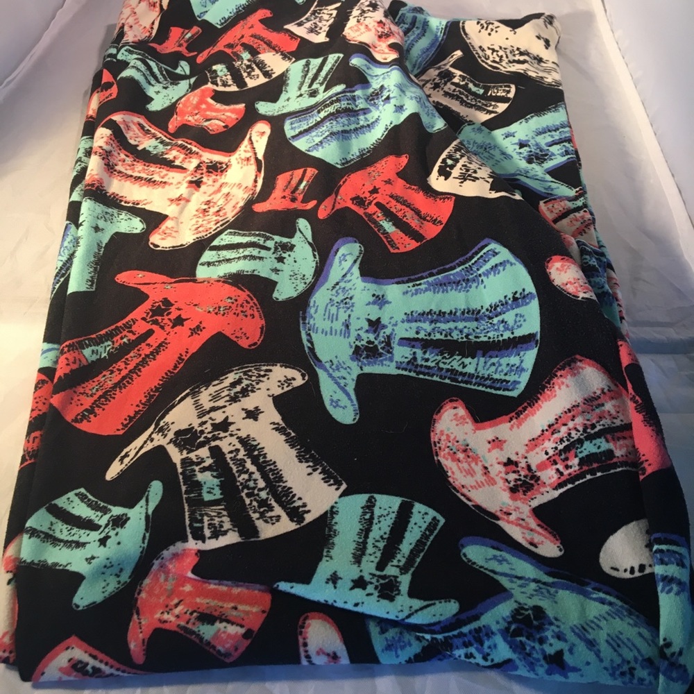 LuLaRoe leggings featuring aqua, cream and red top‎ hats on black background.